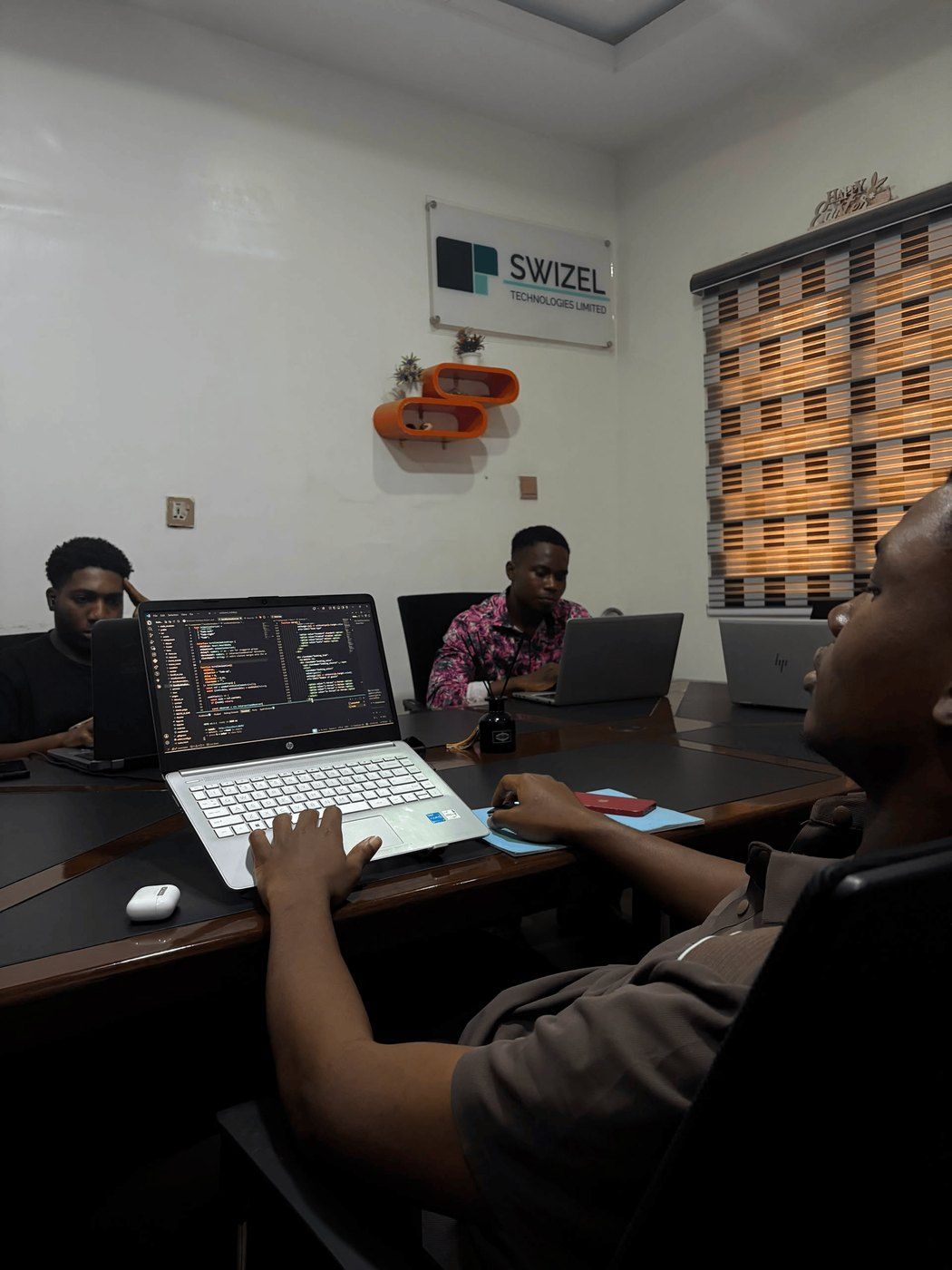 The Swizel studio floor in Abuja, the team heads-down on live builds